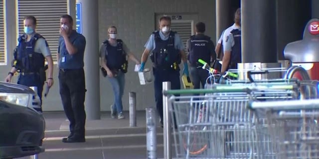 Police investigate the scene outside an Auckland supermarket on Friday, Sep. 3, 2021 in which New Zealand authorities say they shot and killed a violent extremist after he entered a supermarket and stabbed and injured six shoppers in what the country's prime minister called a terror attack.