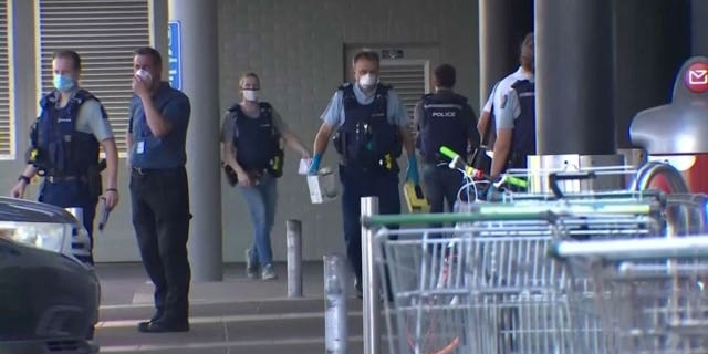 Police investigate the scene outside an Auckland supermarket on Friday, Sep. 3, 2021 in which New Zealand authorities say they shot and killed a violent extremist after he entered a supermarket and stabbed and injured six shoppers in what the country's prime minister called a terror attack.