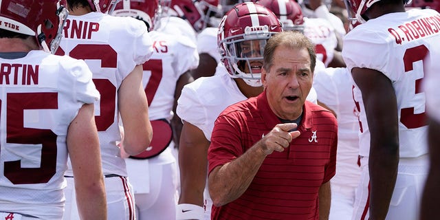 Alabama head coach Nick Saban, center, leads his team on the field during warm ups before an NCAA college football game against Florida, Saturday, Sept. 18, 2021, in Gainesville, Fla.