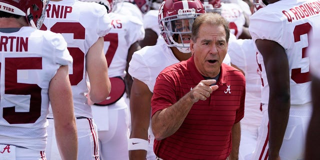 Alabama head coach Nick Saban, center, leads his team on the field during warm ups before an NCAA college football game against Florida, Saturday, Sept. 18, 2021, in Gainesville, Fla.