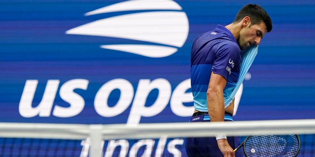 Novak Djokovic, of Serbia, wipes sweat from his face between serves from Daniil Medvedev, of Russia, during the men's singles final of the US Open tennis championships, Sunday, Sept. 12, 2021, in New York. (AP Photo/Elise Amendola)