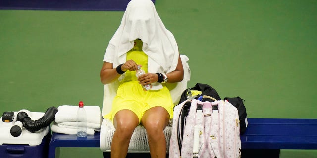 Naomi Osaka, of Japan, covers her head between games against Leylah Fernandez, of Canada, at the third round of the US Open tennis championships, Friday, Sept. 3, 2021, in New York City. (Associated Press)