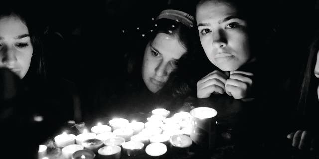 The solemnity and meaning elicited by lighting memorial candles in honor those who perished.