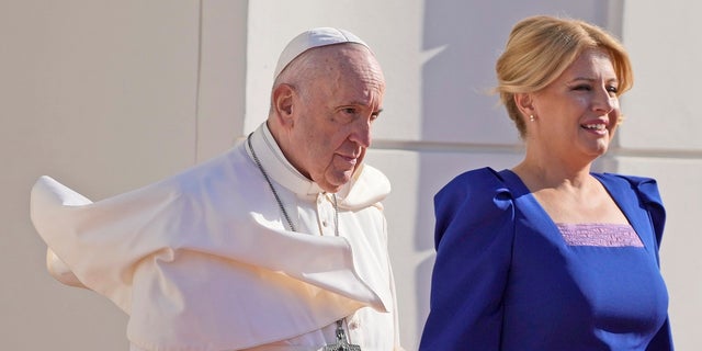 Pope Francis, flanked by Slovakian President Zuzana Caputova, right, attends a welcoming ceremony at the presidential palace in Bratislava, Slovakia, on Monday.