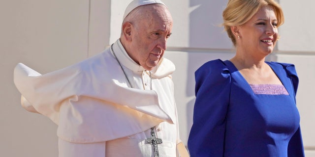 Pope Francis, flanked by Slovakian President Zuzana Caputova, right, attends a welcoming ceremony at the presidential palace in Bratislava, Slovakia, on Monday.