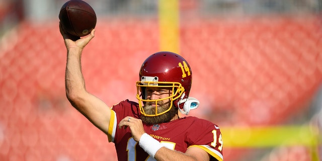 Washington Football Team quarterback Ryan Fitzpatrick (14) in the warm-up before the game before the start of the first half goes to an NFL football game before the season against the Baltimore Ravens on Saturday, August 28, 2021 in Landover, Md.  (AP Photo / Nick Wass)