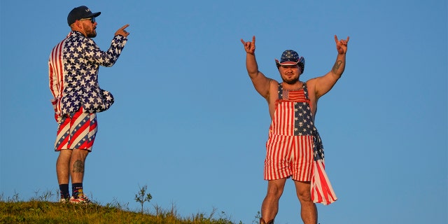 Fans stand on a hill overlooking the third hole during a foursomes match the Ryder Cup at the Whistling Straits Golf Course Saturday, Sept. 25, 2021, in Sheboygan, Wis. (AP Photo/Charlie Neibergall)