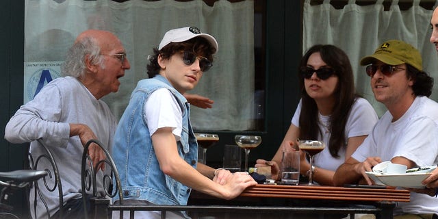 Timothée Chalamet, Larry David and Larry's Daughter are spotted out to eat at Sant Ambroeus in New York City. Chalamet was dressed down from his recent Met Ball appearance, in a baseball cap, denim vest and flame patterned shorts.