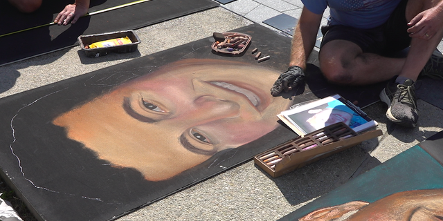 Erick Greenawalt creates a chalk canvas of one of the passengers aboard Flight 93. (FNC/Jayla Whitfield)