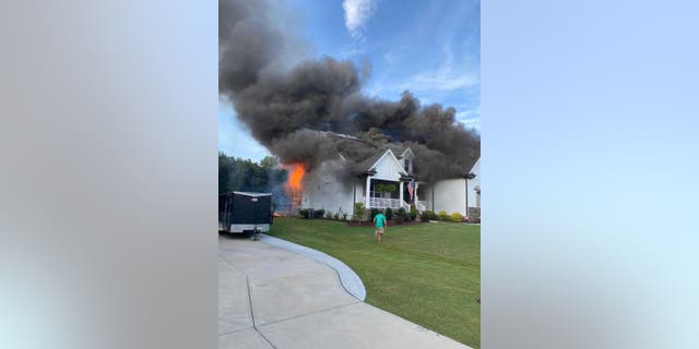 Sean Matthews and Kellie Stanley rushed home while neighbors worked to rescue their 13-year-old dog Memphis. A fire had spread from their front porch to the rest of their home.