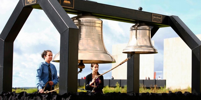 FILE - Matthew Prosser and Gina Rhoads of Shanksville-Stonycreek High School ring the Bells of Remembrance during the service of remembrance tribute to the passengers and crew of Flight 93 at the Flight 93 National Memorial in Shanksville, Pa, Sunday, Sept. 11, 2016, as the nation marks the 15th anniversary of the Sept. 11 attacks. 