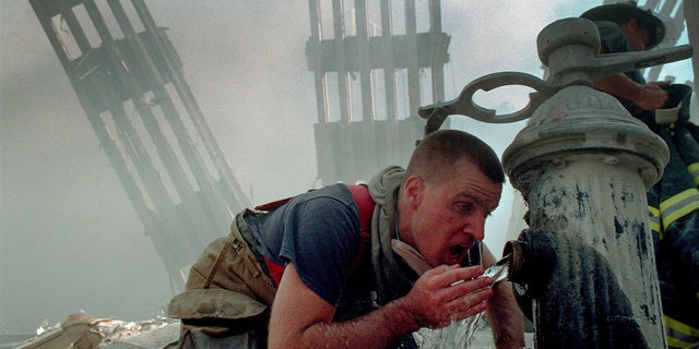 Woodmere Long Island Volunteer Firefighter Michael Sauer drinks from a fire hydrant on 9/11/01.