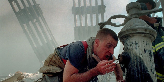 Woodmere Long Island Volunteer Firefighter Michael Sauer drinks from a fire hydrant on 9/11/01.