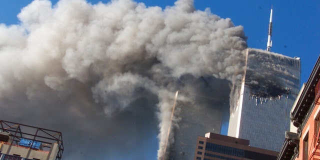 FILE - Smoke rises from the burning twin towers of the World Trade Center after hijacked planes crashed into the towers on September 11, 2001 in New York City.