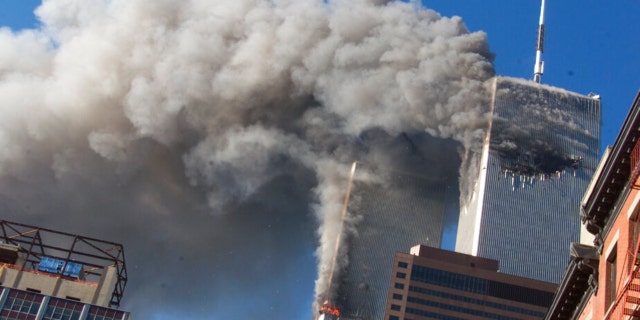 FILE - Smoke rises from the burning twin towers of the World Trade Center after hijacked planes crashed into the towers on September 11, 2001 in New York City.