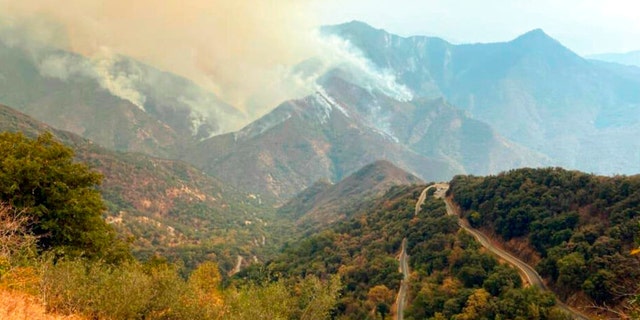 In this Sunday, Sept. 12, 2021 photo released by the KNP Complex Fire Incident Command, smoke plumes rise from the Paradise Fire in Sequoia National Park, Calif. In the southern Sierra Nevada, two fires ignited by lightning are burning in Sequoia National Park. 