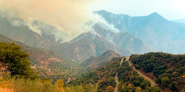 In this Sunday, Sept. 12, 2021 photo released by the KNP Complex Fire Incident Command, smoke plumes rise from the Paradise Fire in Sequoia National Park, Calif. In the southern Sierra Nevada, two fires ignited by lightning are burning in Sequoia National Park. 