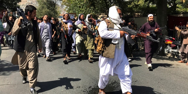 Taliban soldiers march towards Afghans, shouting slogans, during an anti-Pakistani protest near the Pakistani embassy in Kabul, Afghanistan on Tuesday, September 7, 2021 (AP Photo / Wali Sabawoon)