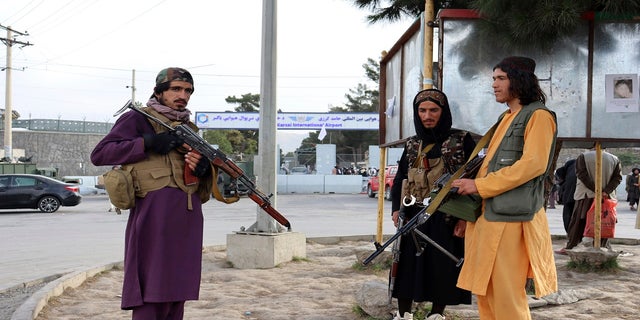 Taliban fighters stand guard in front of the Hamid Karzai International Airport after the U.S. withdrawal in Kabul, Afghanistan, on Tuesday.