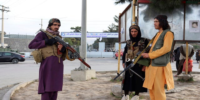 Taliban fighters stand guard in front of the Hamid Karzai International Airport after the U.S. withdrawal in Kabul, Afghanistan, on Tuesday.