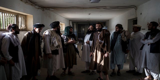 Taliban fighters, some former prisoners, chat in an empty area of the Pul-e-Charkhi prison in Kabul, Afghanistan, on Monday.