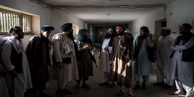 Taliban fighters, some former prisoners, chat in an empty area of the Pul-e-Charkhi prison in Kabul, Afghanistan, on Monday.