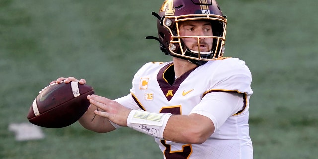 In this file photo from Nov. 7, 2020, Minnesota quarterback Tanner Morgan returns to pitch during the first half of an NCAA college football game against Illinois in Champaign, Illinois. (AP Photo / Charles Rex Arbogast, File)
