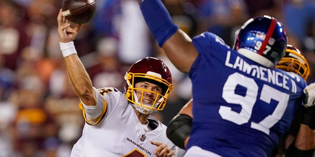 Washington Football Team quarterback Taylor Heinicke (4) throws a touchdown pass to wide receiver Terry McLaurin against the New York Giants during the first half of an NFL football game, Thursday, Sept. 16, 2021, in Landover, Md. (AP Photo/Alex Brandon)
