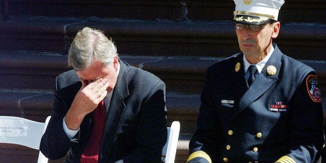 New York City Fire Commissioner Thomas Von Essen, 剩下, rubs his eyes while then-New York City Mayor Rudolph Giuliani spoke at an NYFD promotions ceremony near NYFD headquarters in Brooklyn, 纽约, 在9月. 16, 2001.