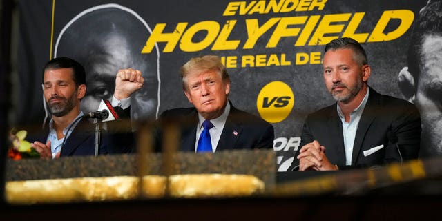 Former President Donald Trump, center, greets enthusiastic fans and he and his son Donald Trump Jr., left, prepare to comment on a boxing event featuring a fight between former heavyweight champion Evander Holyfield and former MMA star Vitor Belfort on Saturday September 7th.  November 11, 2021 in Hollywood, Florida (AP Photo / Rebecca Blackwell)