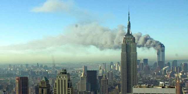 FILE - The twin towers of the World Trade Center burn behind the Empire State Building, Tuesday Sept. 11, 2001. in New York. 