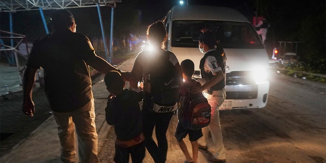 Mexican immigration agents detain a Central American migrant who is part of a caravan heading north in Huixtla, Mexico, Sept. 5, 2021. (AP Photo/Marco Ugarte)