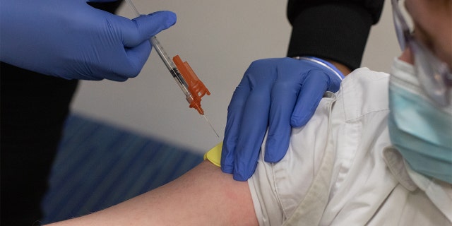 A healthcare worker administers a dose of a Pfizer-BioNTech Covid-19 vaccine to a child at a pediatrician's office in Bingham Farms, Michigan, U.S., on Wednesday, May 19, 2021. Anthony Fauci, head of the National Institute of Allergy and Infectious Diseases, said in a MSNBC interview that he expects all children will be eligible for a Pfizer-BioNTech Covid-19 vaccine by the end of the year. Photographer: Emily Elconin/Bloomberg via Getty Images