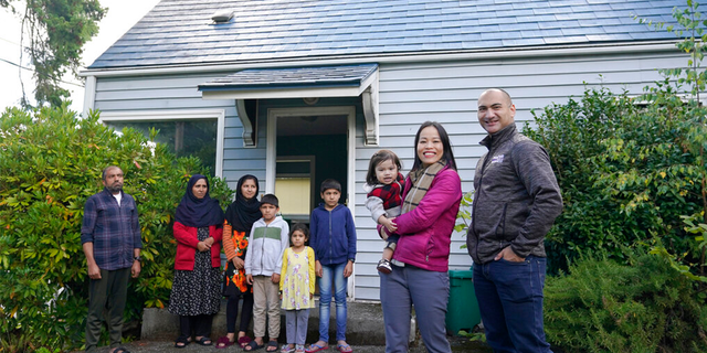 Thuy Do, second from right, poses for a photo with her husband, Jesse Robbins, right, and their son, Fredrick, Monday, Sept. 20, 2021.