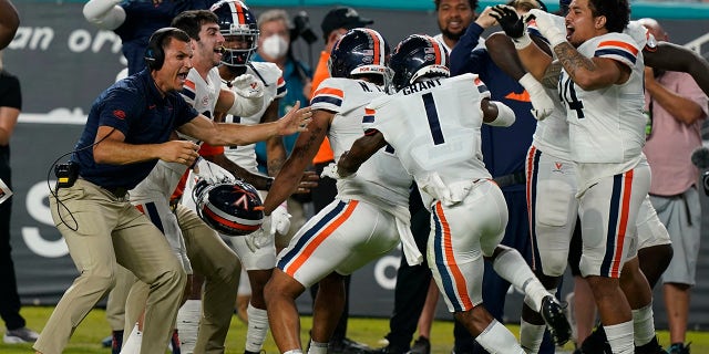 Virginia celebrates after scoring a safety during the first half of an NCAA college football game against Miami on Thursday, September 30, 2021, in Miami Gardens, Fla.