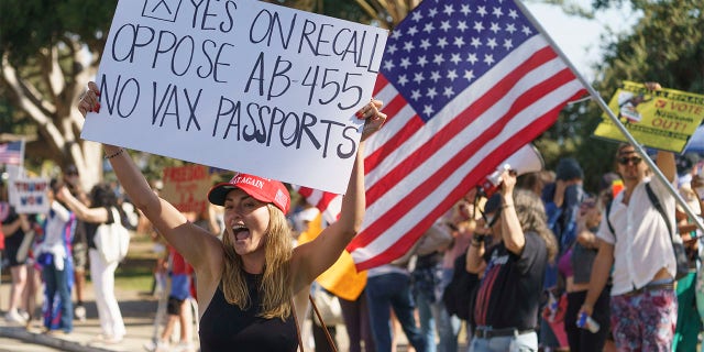 Demonstrator Angelita Roman rallies against COVID-19 vaccines and passport mandates in Santa Monica, Calif., on Aug. 29, 2021. The City Council on Tuesday voted to approve an ordinance that would bar protests within 300 feet of a target’s home. 