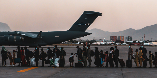 vacuees wait to board a Boeing C-17 Globemaster III during an evacuation at Hamid Karzai International Airport, Kabul, Afghanistan, Aug. 23. (U.S. Marine Corps photo by Sgt. Isaiah Campbell)