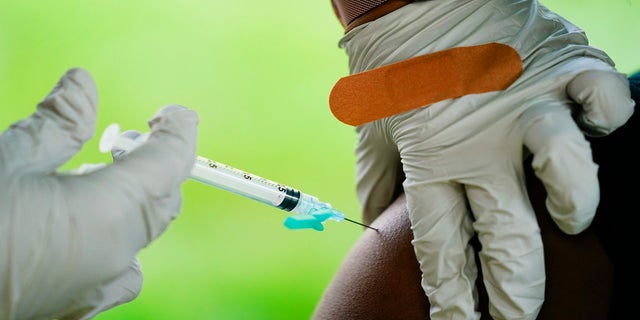 Sept. 14, 2021: A health worker administers a dose of a Pfizer COVID-19 vaccine during a vaccination clinic at the Reading Area Community College in Reading, Pa. 