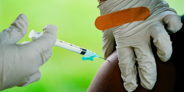 Sept.. 14, 2021: A health worker administers a dose of a Pfizer COVID-19 vaccine during a vaccination clinic at the Reading Area Community College in Reading, Wel.