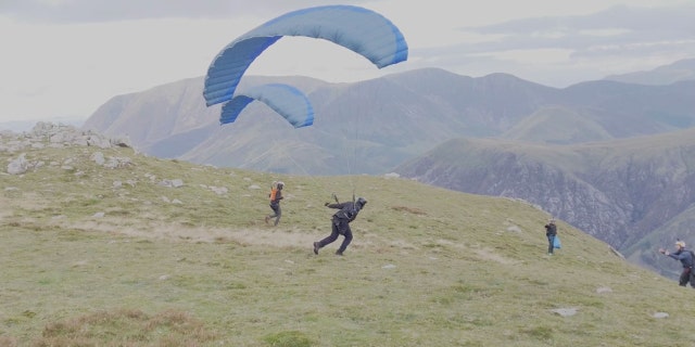 Cruise parachuted off a cliff. He was practicing a stunt for his upcoming movie.
