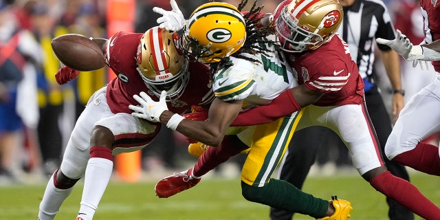 Green Bay Packers wide receiver Davante Adams, middle, cannot catch a pass between San Francisco 49ers cornerback Jimmie Ward, left, and defensive back Emmanuel Moseley during the second half of an NFL football game in Santa Clara, Calif., Sunday, Sept. 26, 2021. 