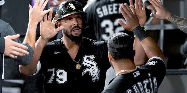 Chicago White Sox's Jose Abreu is congratulated in the dugout after scoring on a single by Yasmani Grandal during the sixth inning of the team's baseball game against the Los Angeles Angels on Wednesday, Sept. 15, 2021, in Chicago.
