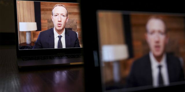 Facebook Inc. CEO Mark Zuckerberg speaks on a laptop computer during a House Energy and Commerce subcommittee hearing Thursday, March 25, 2021, in Tiskillwa, Illinois, U.S. 