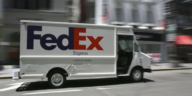 A FedEx delivery truck drives through Union Square in San Francisco.