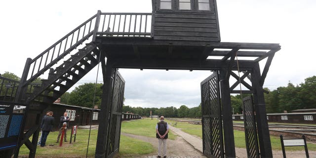 The wooden main gate leads into the former Nazi German Stutthof concentration camp in Sztutowo, Poland. An elderly secretary of the former SS commandant of Stutthof was going on trial Thursday in Germany on charges of more than 11,000 counts of accessory to murder. (AP Photo/Czarek Sokolowski, file)