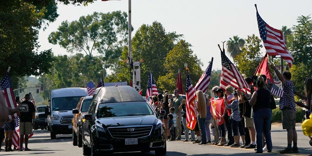 A hearse carrying the body of United States Marine, Lance Cpl.  Kareem M. Nikoui made his way among the main thoroughfare on Friday September 17, 2021, in Norco, Calif. Nikoui along with ten other Marines, a Navy corpsman and a soldier were killed on August 26, 2021, following a enemy attack while supporting evacuation operations outside Hamid Karzai International Airport in Kabul, Afghanistan.  (AP Photo / Marcio José Sanchez)