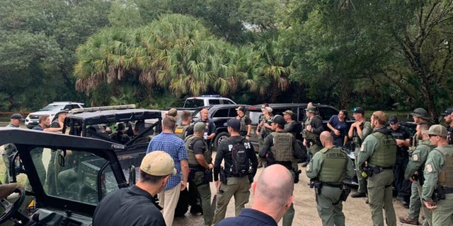 Law enforcement officials conduct a search of the vast Carlton Reserve in the Sarasota, Florida, area for Brian Laundrie on Saturday, Sept. 18, 2021.  (North Port Police Department via AP)