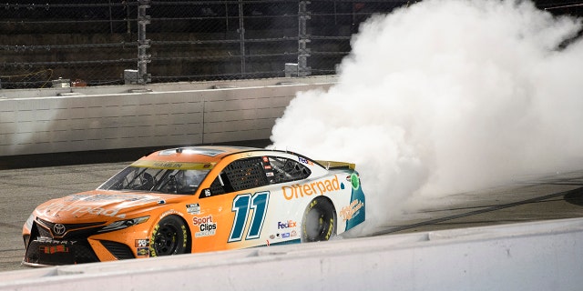 Denny Hamlin does a burnout after winning a NASCAR Cup Series auto race Sunday, Sept. 5, 2021, in Darlington, S.C. (AP Photo/John Amis)