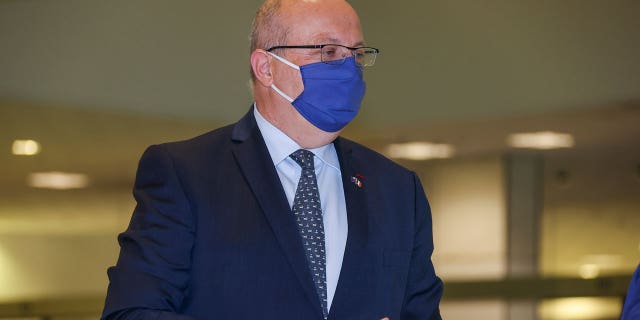 France's Ambassador to Australia Jean-Pierre Thebault gestures as he arrives at Sydney Airport, Saturday, Sept. 18, 2021. Thebault has described as a