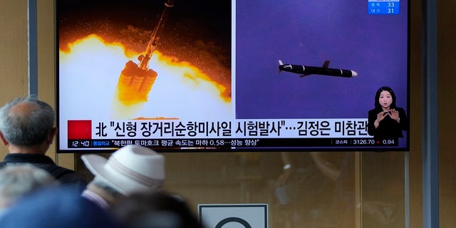 People watch a TV screen showing a news program reporting about North Korea's long-range cruise missiles tests with images in Seoul, South Korea, on Monday. (Associated Press)